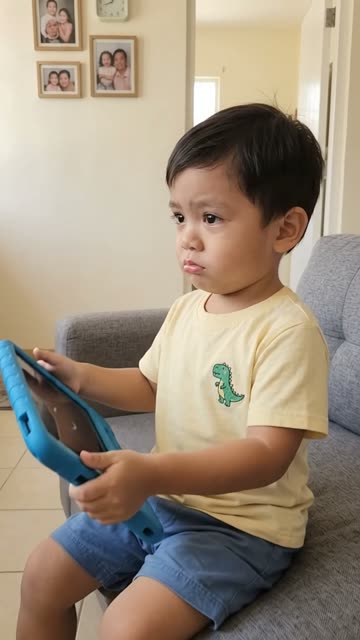 Scene 1: Isko on the sofa holding the tablet